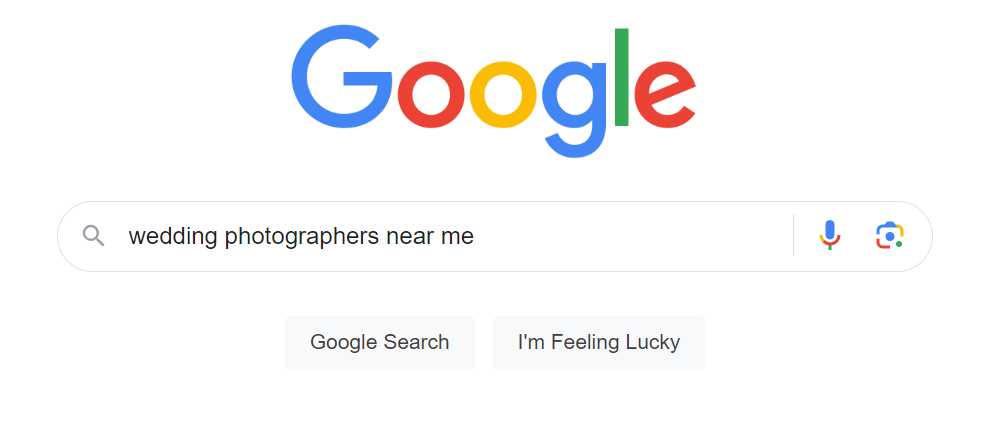 A screenshot of the Google homepage with the "wedding photographers near me" keyword in the search field.